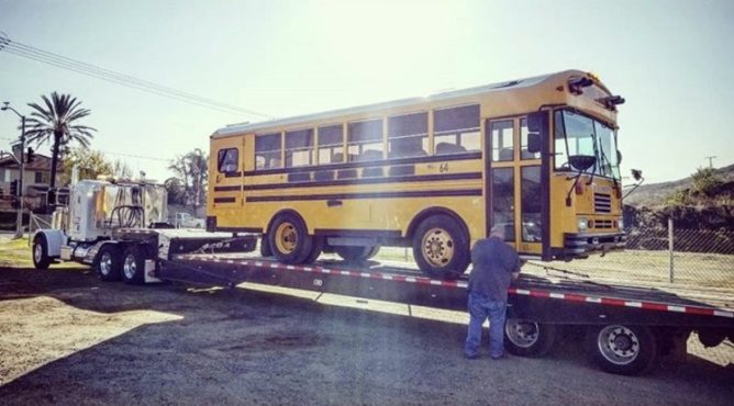 Heavy Duty Flatbed Towing Truck towing a School Bus in Temecula CA - Rancho Towing