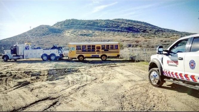 Heavy Duty Towing Truck towing a School Bus in Temecula CA - Rancho Towing