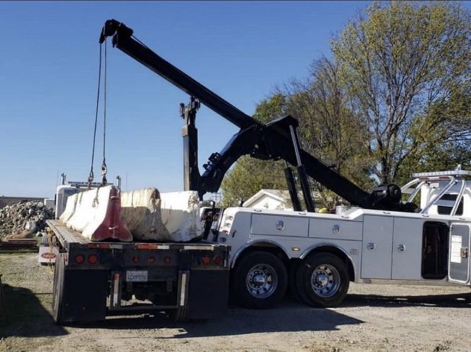 Heavy Duty Towing Truck lifting cement barriers in Temecula CA - Rancho Towing