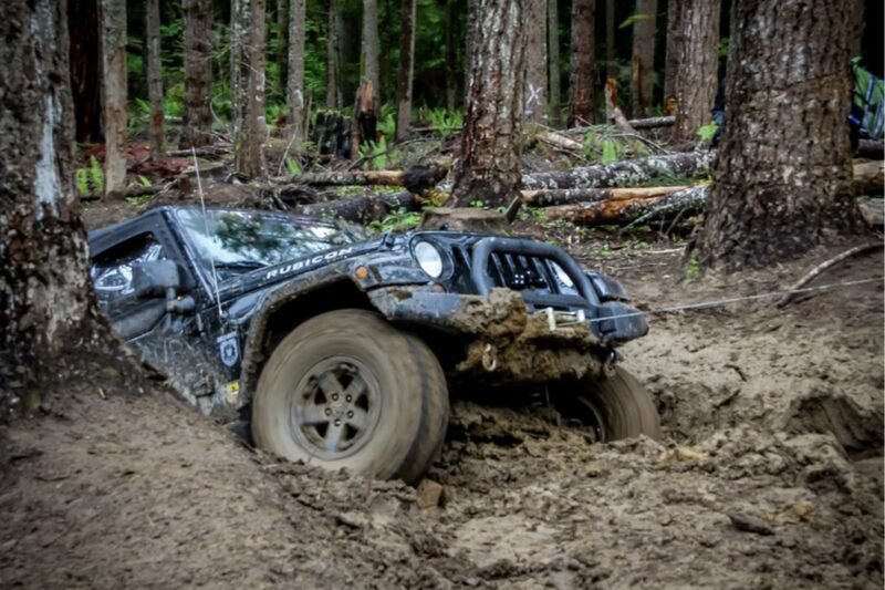 Jeep winchout A jeep stuck in mud being winched out